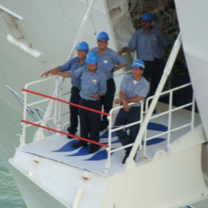 Crewmembers wave goodbye