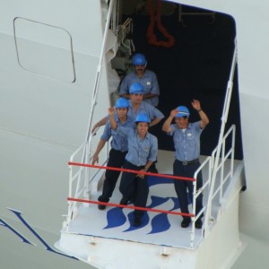 Crewmembers wave goodbye