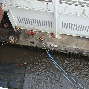 Dock workers secure the lines