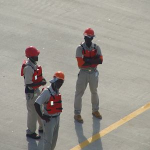 Dockworkers await our arrival