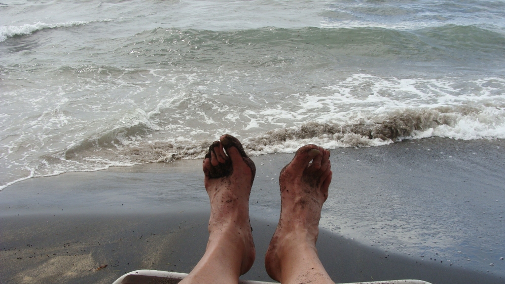 Black sand on my feet