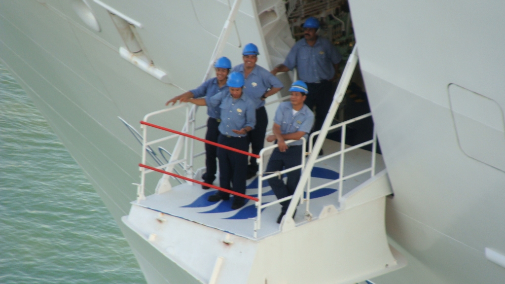 Crewmembers wave goodbye