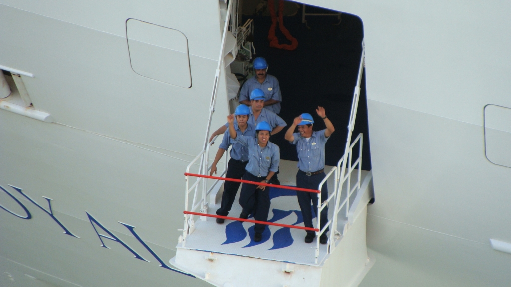 Crewmembers wave goodbye