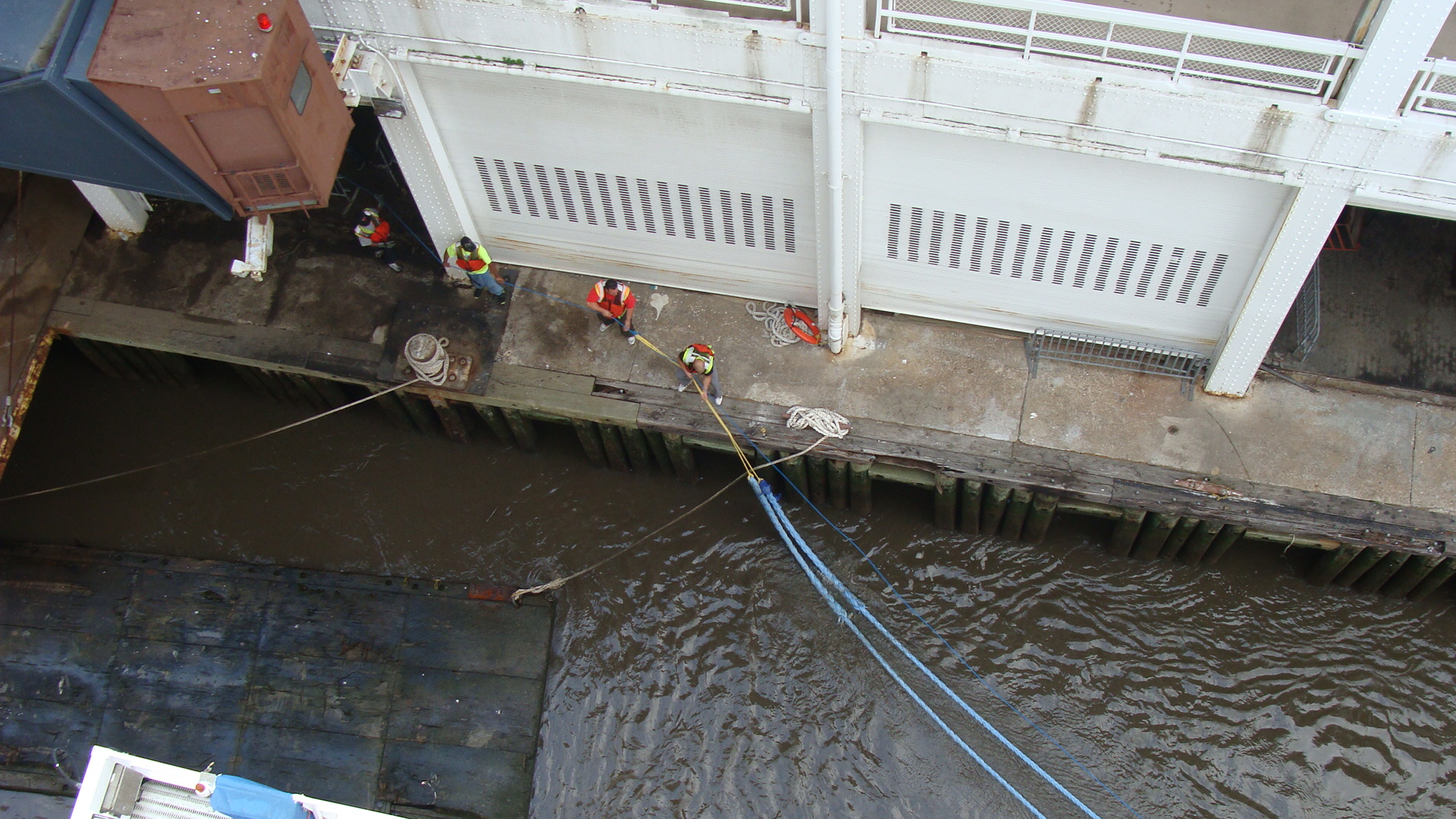 Dock workers secure the lines