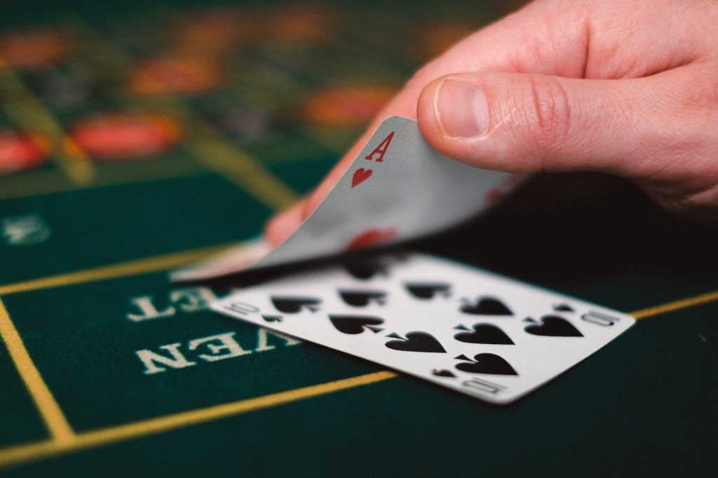 close up of person with cards in casino